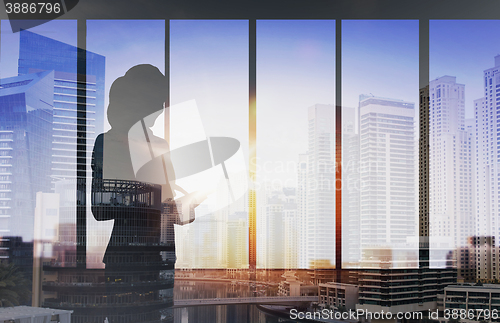 Image of silhouette of businesswoman with tablet pc