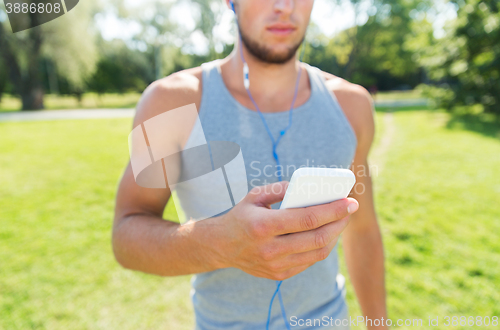 Image of close up of man with smartphone listening to music