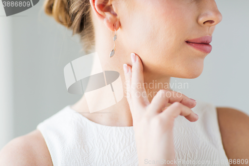 Image of close up of beautiful woman face with gold earring