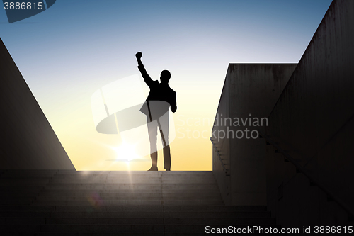 Image of silhouette of business man with over sun light