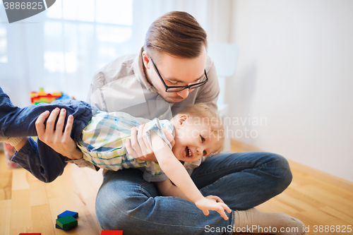 Image of father with son playing and having fun at home