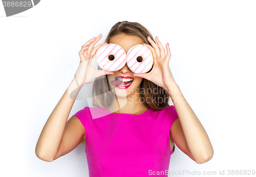 Image of happy woman or teen girl looking through donuts