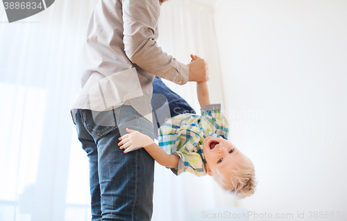 Image of father with son playing and having fun at home