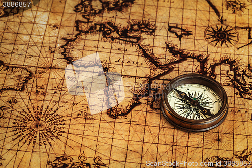 Image of Old vintage compass on ancient map