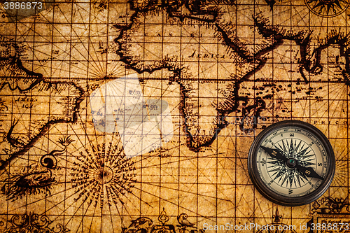 Image of Old vintage compass on ancient map