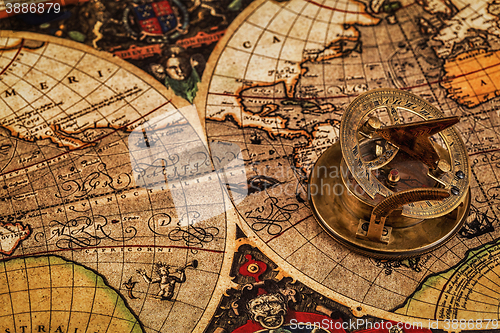 Image of Old vintage compass on ancient map