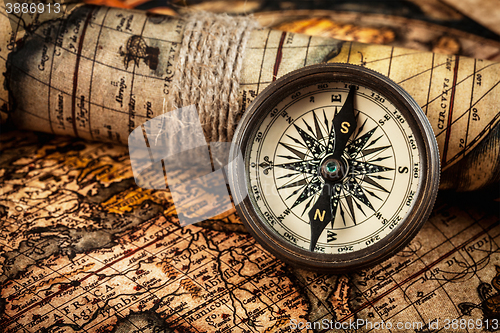 Image of Old vintage compass on ancient map