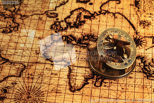 Image of Old vintage compass on ancient map