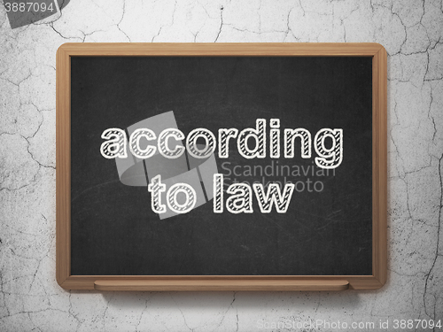 Image of Law concept: According To Law on chalkboard background