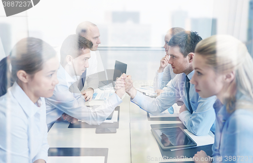 Image of smiling business people having conflict in office