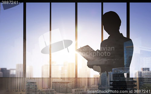Image of silhouette of woman with clipboard over city