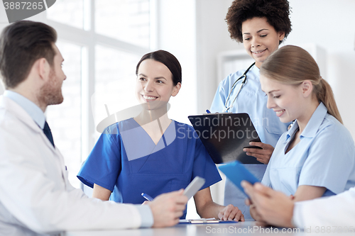 Image of group of happy doctors meeting at hospital office