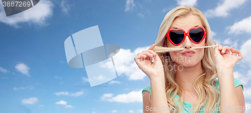 Image of happy young woman making mustache with her hair