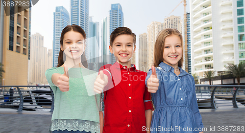 Image of happy boy and girls showing thumbs up