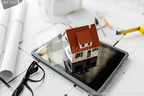 Image of close up of living house model on tablet pc