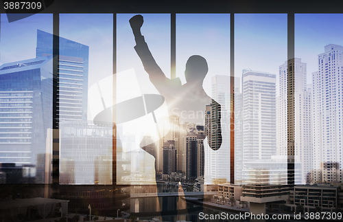 Image of silhouette of business man over city background