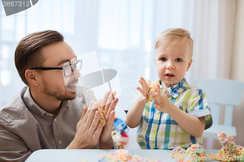 Image of father and son playing with ball clay at home