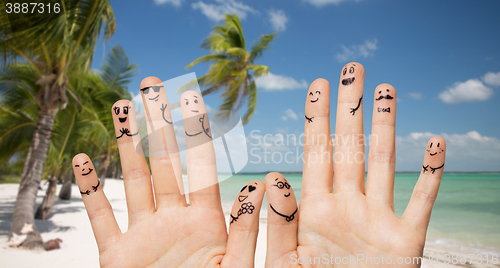 Image of close up of hands and fingers with smiley faces