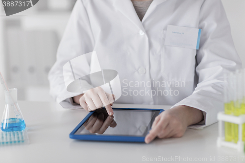 Image of close up of scientist with tablet pc in lab