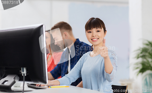 Image of happy creative team or students working at office