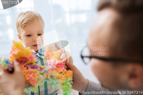 Image of father and son playing with ball clay at home