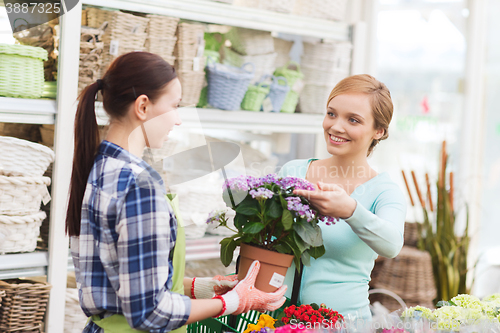 Image of happy women choosing flowers in greenhouse