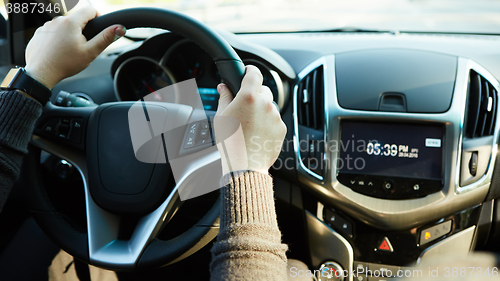 Image of Close-up Of A Man Hands Holding Steering Wheel While Driving Car