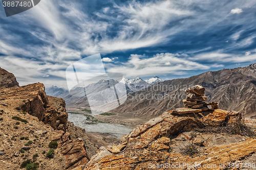 Image of View of valley in Himalayas with stone cairn on cliff