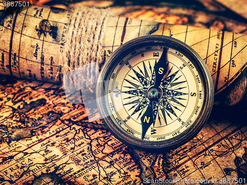 Image of Old vintage compass on ancient map