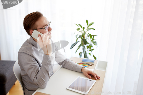 Image of creative male worker calling on smarphone