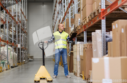 Image of man with loader and clipboard at warehouse