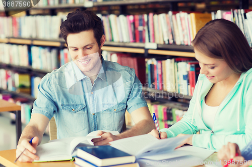 Image of students with books preparing to exam in library