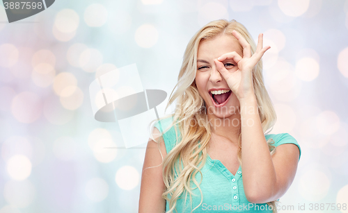 Image of young woman making ok hand gesture