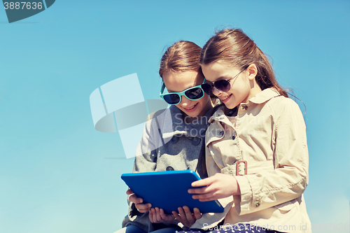 Image of happy girls with tablet pc computer outdoors