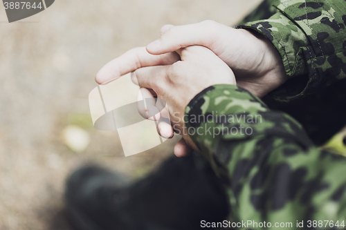 Image of close up of young soldier in military uniform