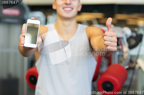 Image of close up of man with smartphone in gym