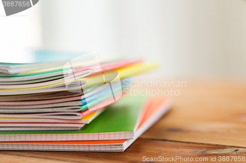 Image of close up of notebooks on wooden table