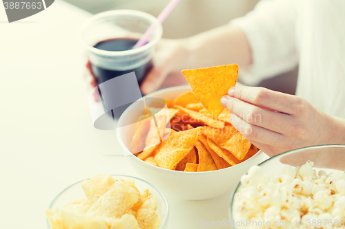 Image of close up of woman with junk food and coca cola cup