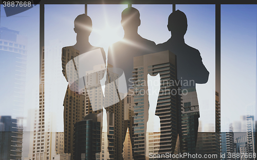 Image of business people silhouettes over office background