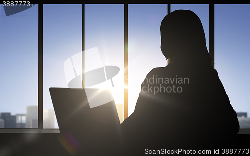 Image of silhouette of business woman with laptop