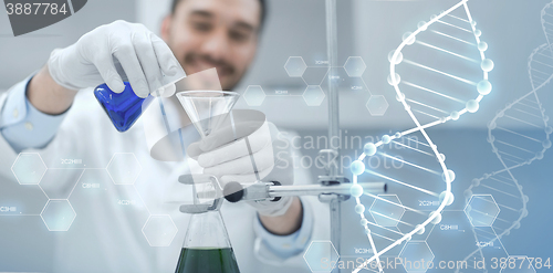 Image of close up of scientist with test tubes and funnel