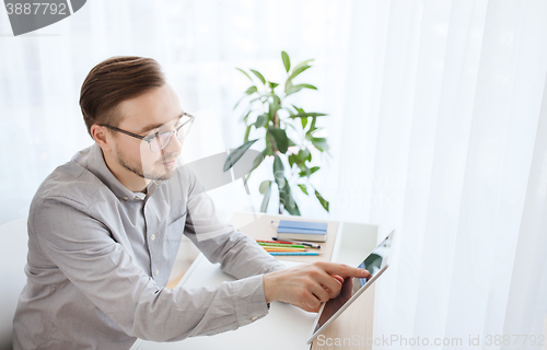 Image of happy creative male office worker with tablet pc