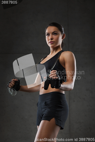 Image of young sporty woman with jumping rope