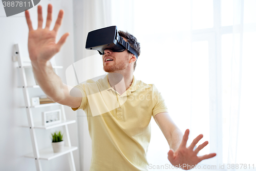 Image of young man in virtual reality headset or 3d glasses