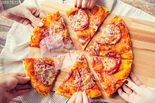 Image of close up of hands and homemade pizza