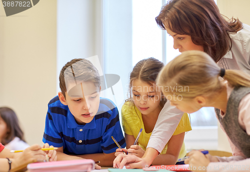 Image of group of school kids writing test in classroom