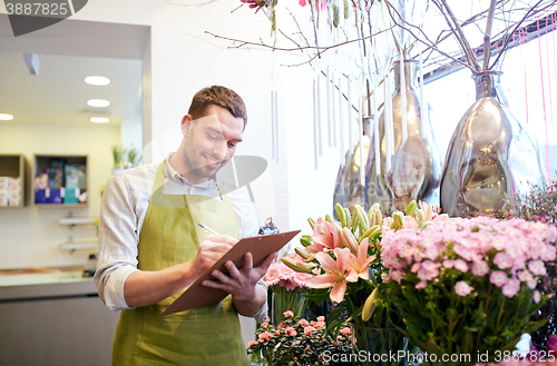 Image of florist man with clipboard at flower shop