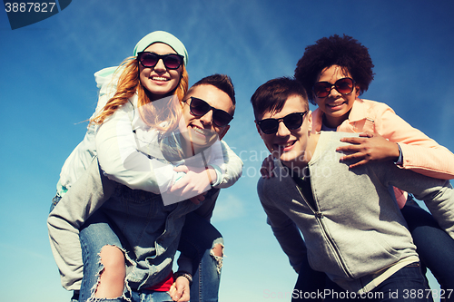 Image of happy friends in shades having fun outdoors