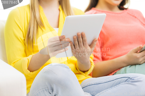 Image of close up of young women with tablet pc at home