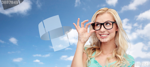 Image of happy young woman or teenage girl in glasses